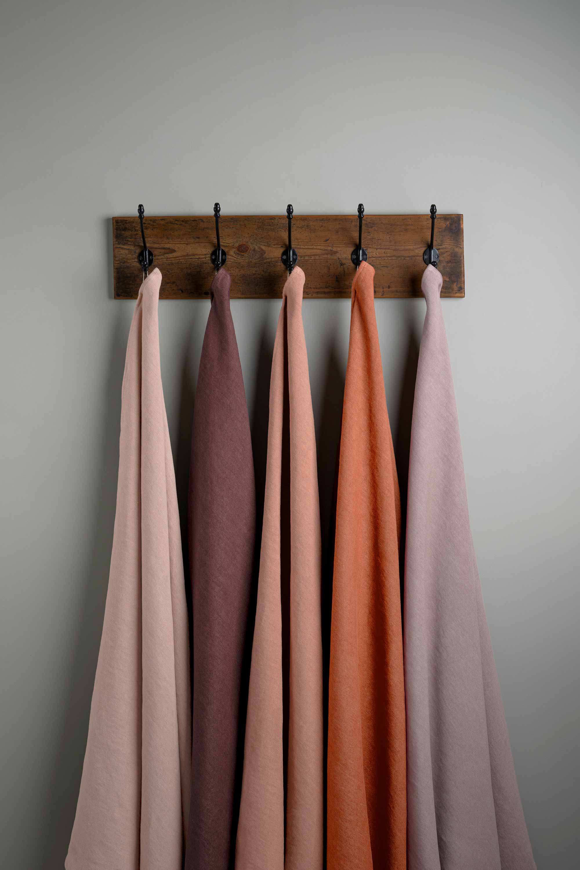  Linen Fabric Swatches in Different Colors Hanging on Hooks – By NiX 