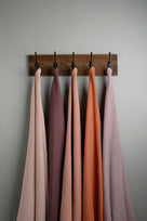  Linen Fabric Swatches in Different Colors Hanging on Hooks – By NiX 